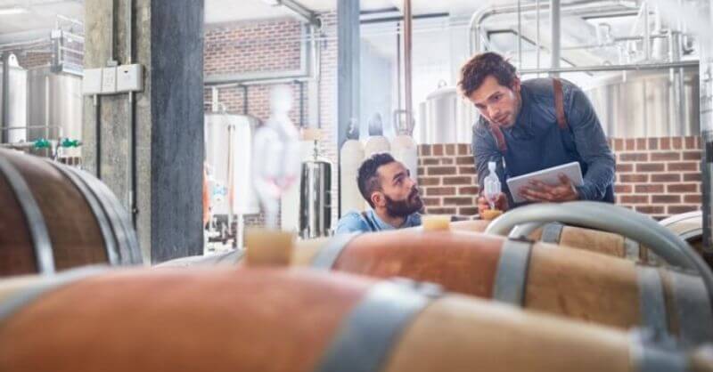 men in the winery