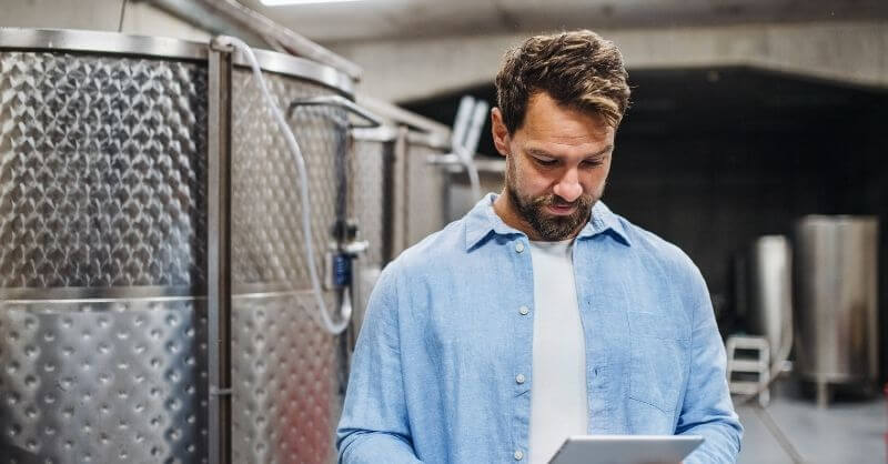 man in winery with ipad